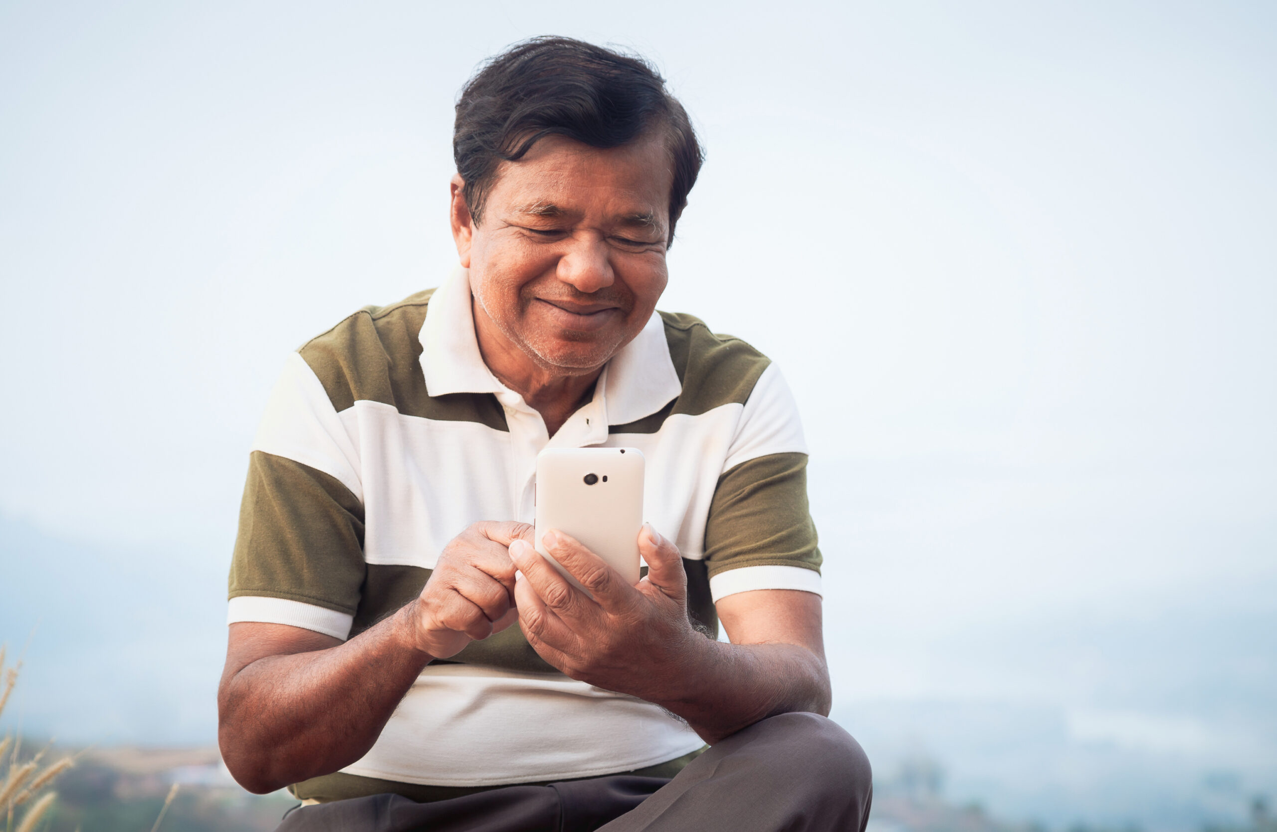 older man chatting with doctor on phone