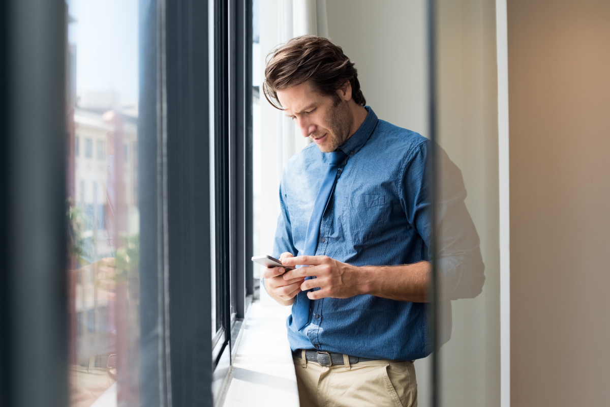 man texting his doctor in an office setting