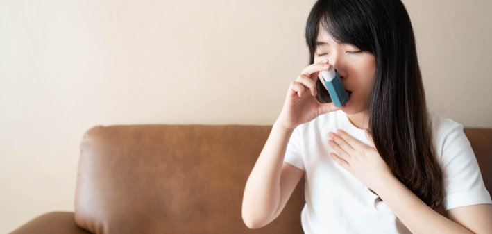 Woman using inhaler