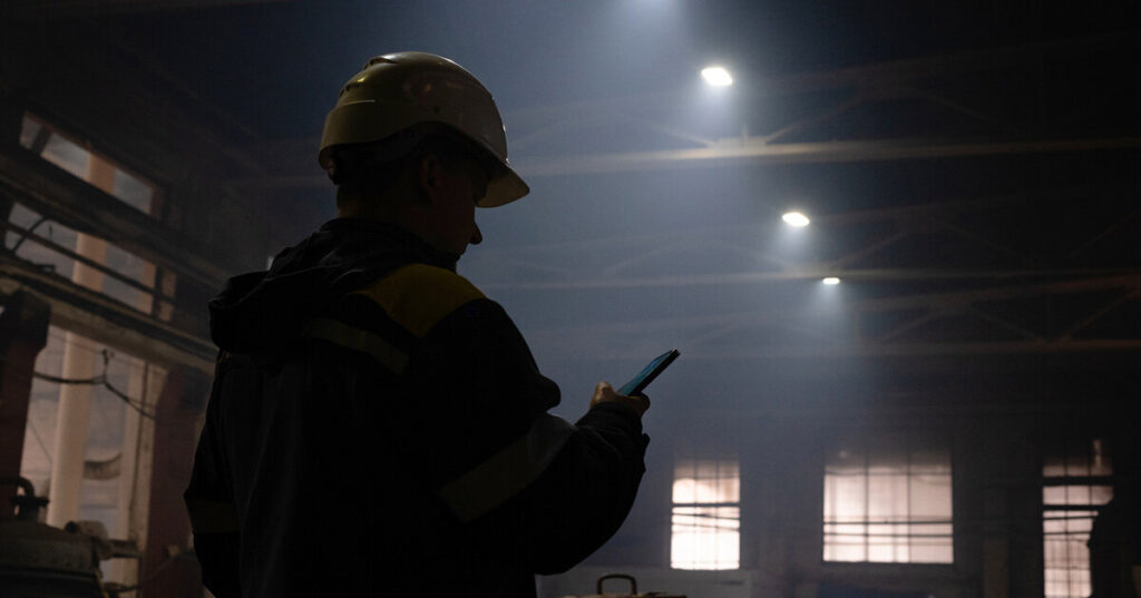 Warehouse Worker Having a Telehealth Visit in Warehouse