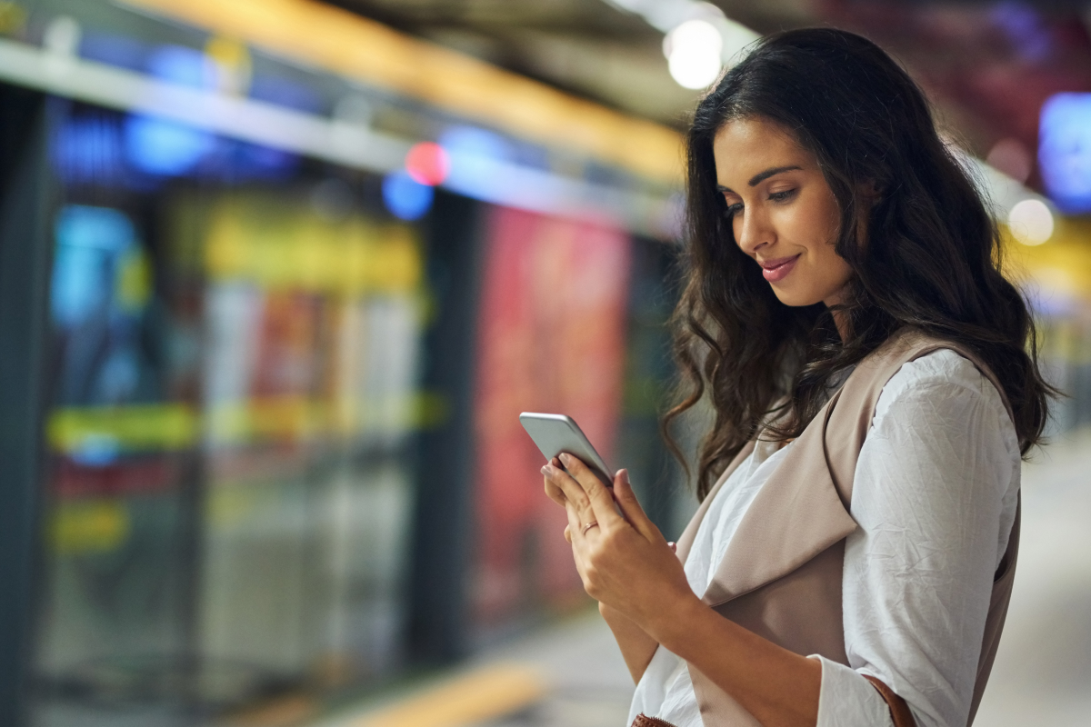 woman texting with doctor in train station