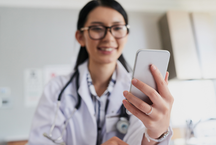 woman smiling and chatting with her doctor