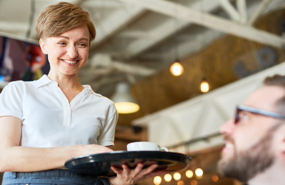 Smiling retail worker at checkout