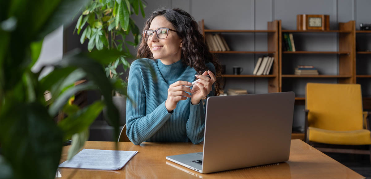 young woman using virtual primary care on laptop