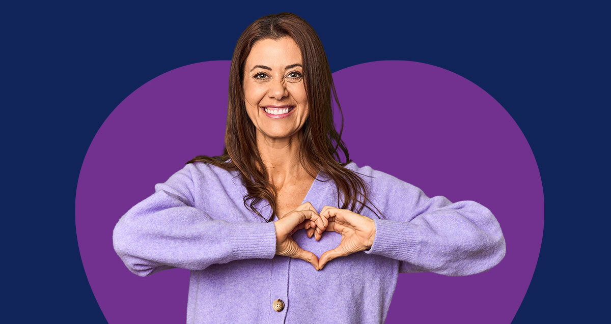 How to use virtual care for better heart health. Woman smiling making heart with hands.