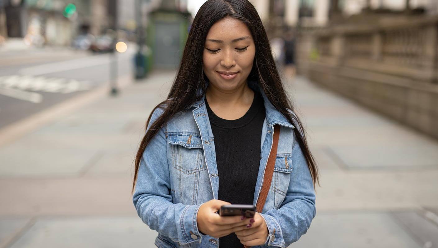 woman using her phone for virtual care and behavioral health concerns